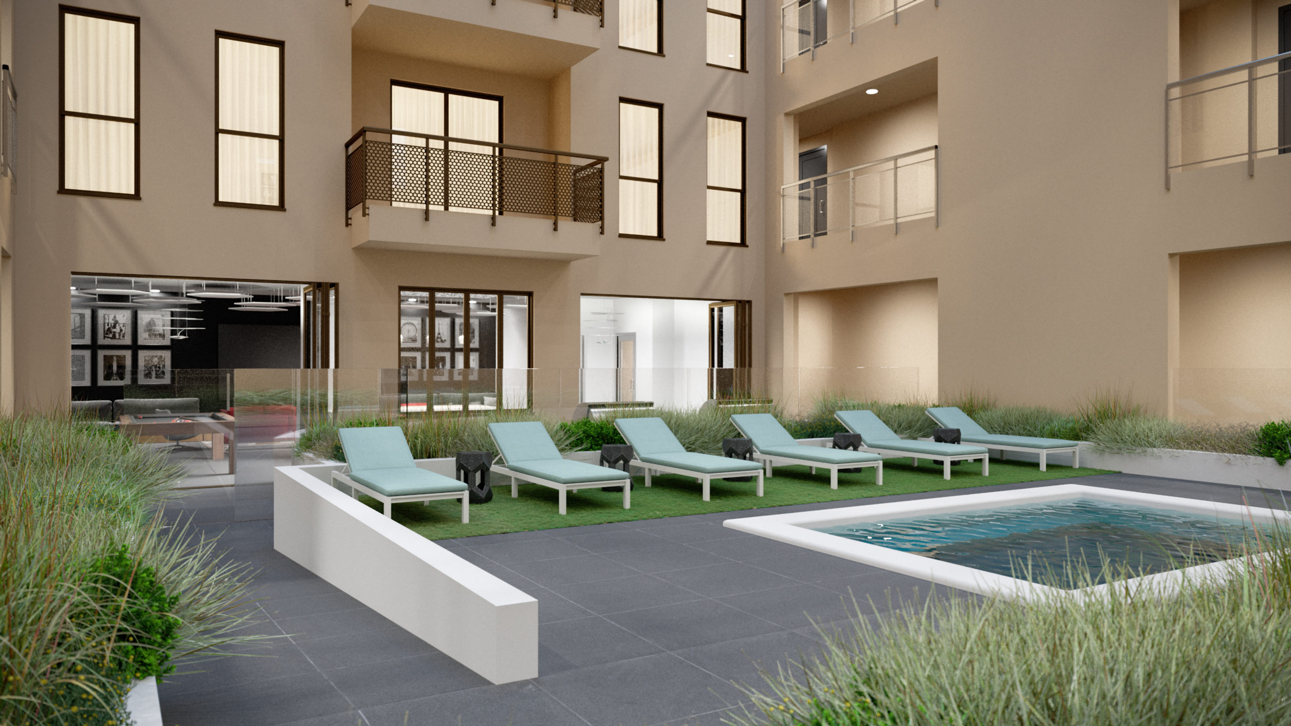 outdoor deck area with spa, gardens, balconies, and sun bathing beds