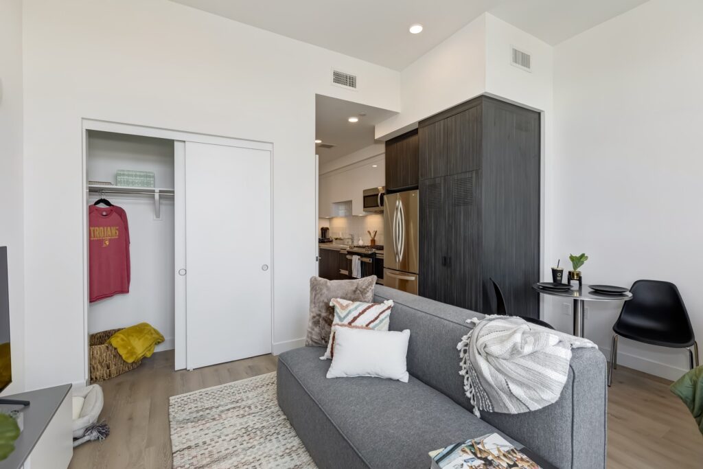 living area with sliding closet, couch, view of kitchen, and decor