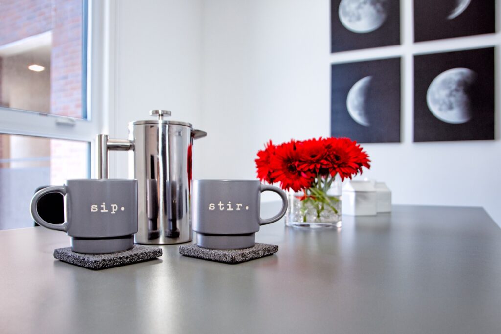 Close up of dining room table with a coffee mug set and outdoor lighting