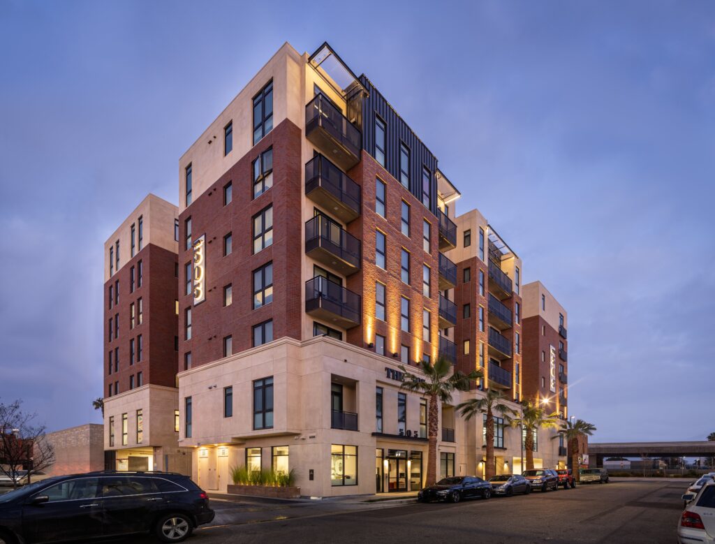 Close aerial shot of the apartment complex with parked cars